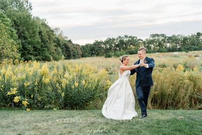 bride and groom dancing in the field at barnwood events, a wedding venue in madison, winconsin.