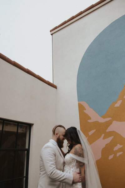 wedding elopement couple at no vacancy hotel courtyard. Intimate wedding reception at hotel courtyard for candid bride and groom