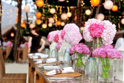 pink flowers on a large oak table