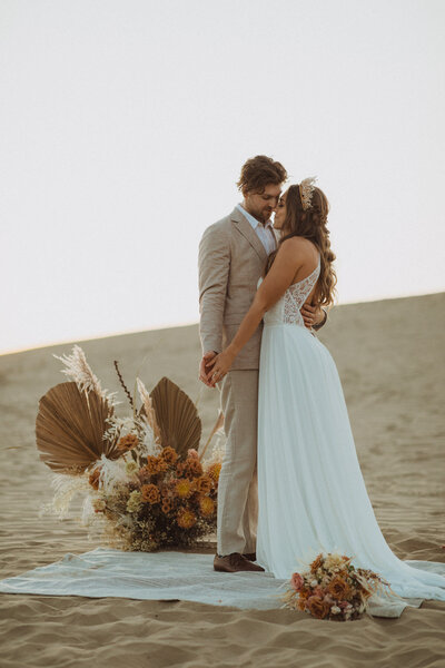 couple eloping in the sand dunes, moroccan style