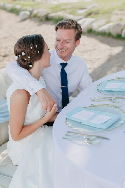 wedding couple at sweetheart table on Minnesota beach