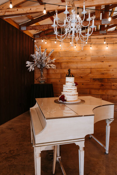 piano with cake sitting on top of it