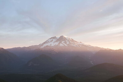 sunrise behind snow covered mount rainier