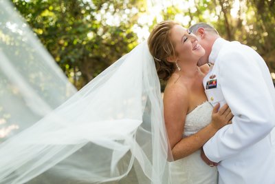Groom kissing bride at their wedding we Twin Oaks Garden Estate