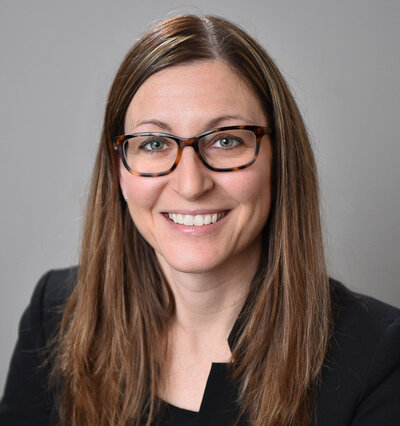 Business headshot of woman wearing glasses