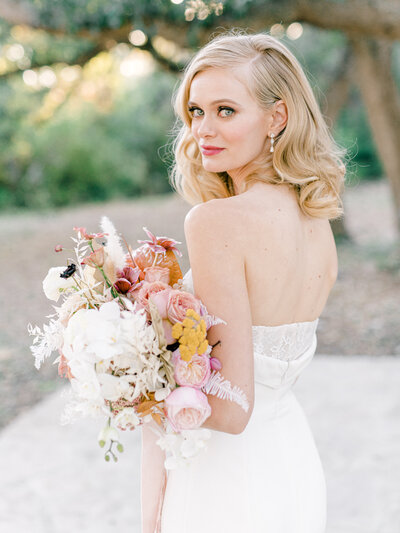 bride looking over shoulder with romantic florals
