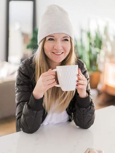 Woman in toque drinking coffee
