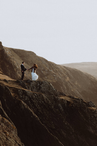 Wedding couple standing on coastline