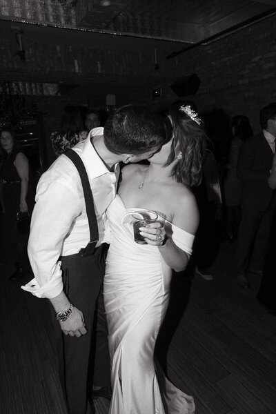 A flash photo of a couple kissing on the dance floor