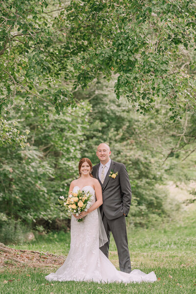 A beautiful couple on their wedding day under an oak tree during sunset enjoying their destination wedding photos by JoLynn Photography