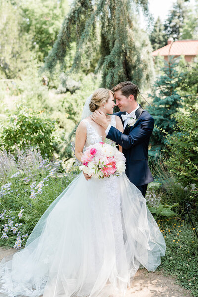 A romantic summer wedding at the Denver Botanic Garden where couple kisses