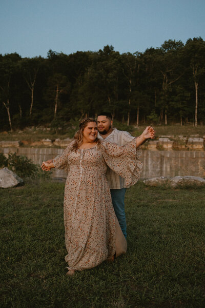 couple dancing together in grassy area