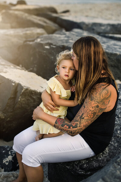 mother holds daughter for photos at  New Jersey beach photography session
