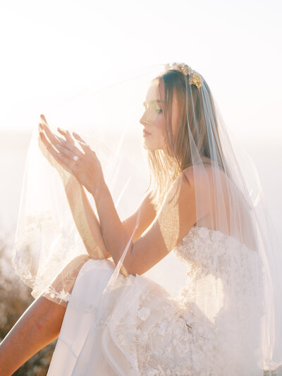 bride sitting on rock at sunset looking through veil at golden hour, bridal portait at golden hour, bridal portrait san francisco wedding, san francisco wedding photographer