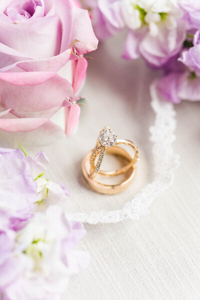 wedding ring flat lay with purple flowers