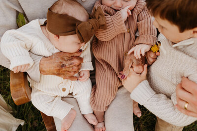 twins and little boy holding hands