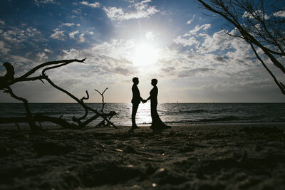 Two Brides holding hands on the Beach in Naples for their Elopement in Maui