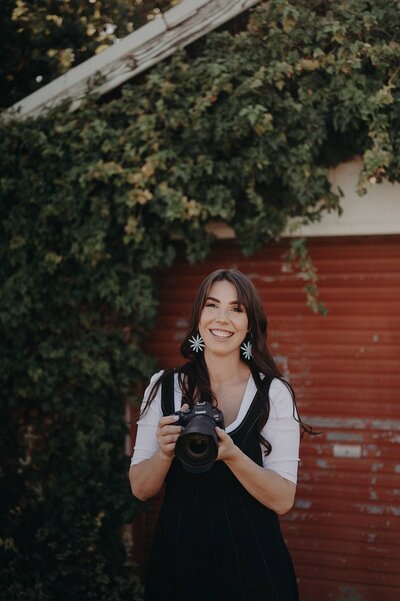 Creative branding photo of Sharni sitting against a pastel painted wall during a lifestyle shoot.
