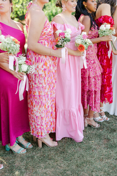 a mix of bright pink patterned bridesmaid dresses