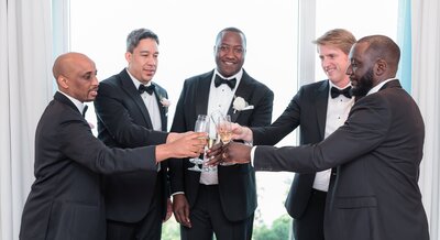 Groom cheersing with groomsmen, Destination Wedding at The Palms Hotel in Miami, FL