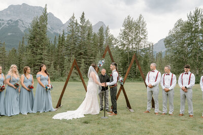 Family of 3 during a family photo session in Lake Minnewanka in Banff National Park