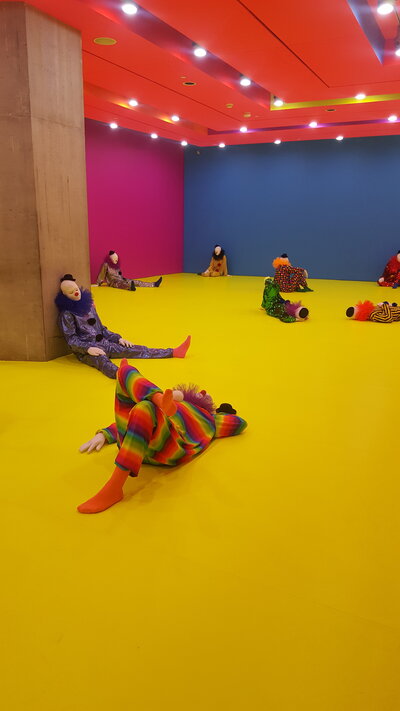 Multi-Colored Room with clowns in various sitting and laying positions