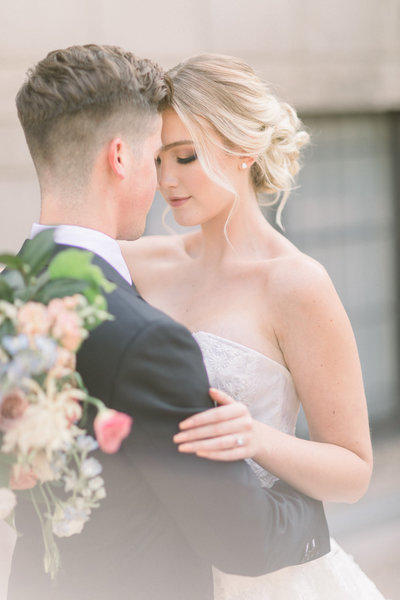 Bride and Groom embrace during a tender moment