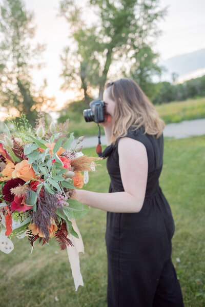 Seattle Wedding Photographer captures woman holding bouquet taking pictures