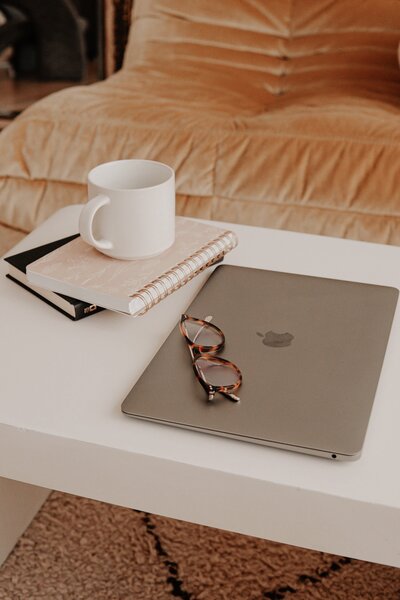 Mac book and journal sitting on desk