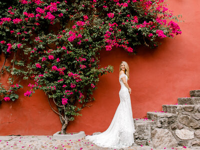 smiling bride against red wall