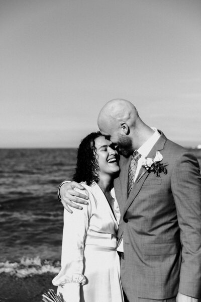Couple embraces on Lake Michigan shore after their Chicago elopement ceremony