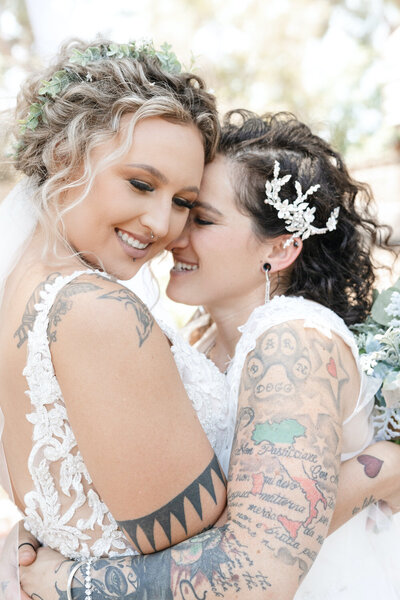 Brides Caitlin & Brenna embrace after they say "I do"