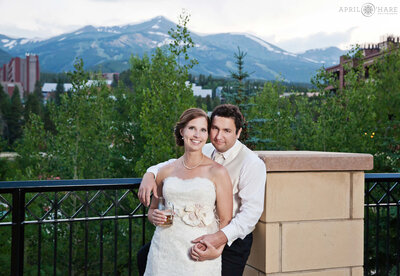 Couple pose in front of mountain view at Breckenridge's Main Street Station Wedding Venue in Colorado