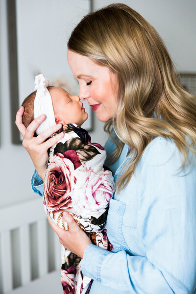 lifestyle newborn photo of mom and baby nose to nose