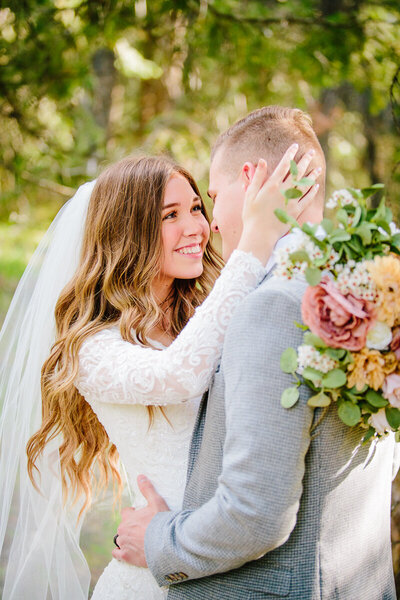 Jackson Hole photographers capture bride and groom hugging after outdoor wedding
