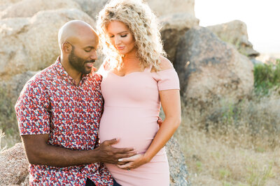 mom and dad to be holding baby bump in Scottsdale maternity photography session