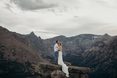 elopement couple standing on top of a mountain in rocky mountain national park