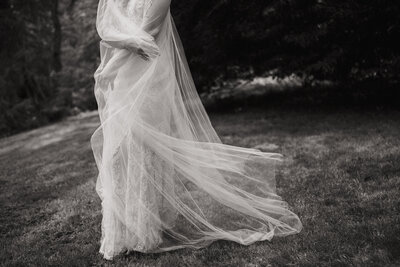 black and white image of bride with veil