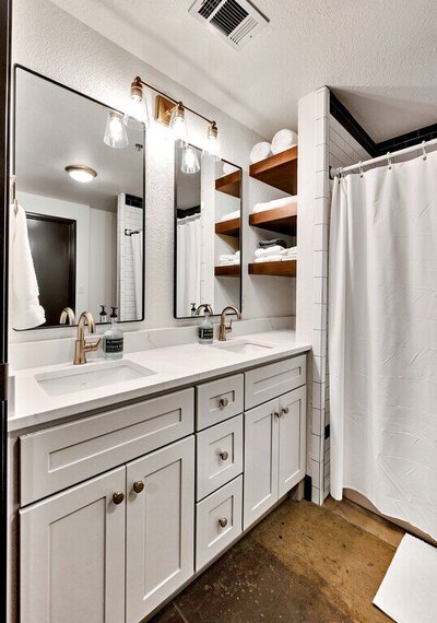 Bathroom vanity with dual sinks in this three-bedroom, two-bathroom vacation rental condo in the historic Behrens building in downtown Waco, TX.