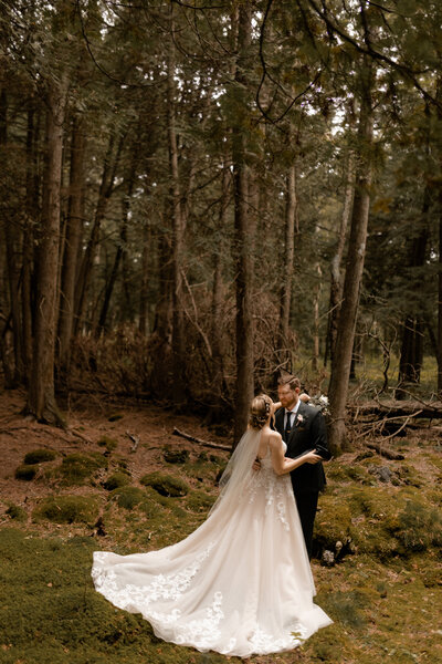 Couple adventuring during their forest elopement