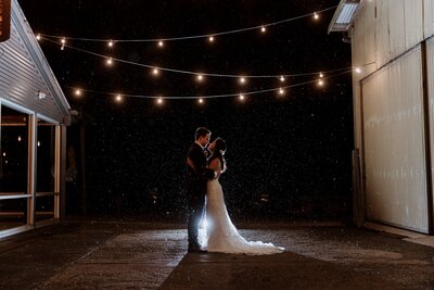 Romantic wedding photography of a couple getting married at Zonzo Estate under the festoon lights