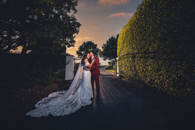 Bride and groom laughing and holding hands amid the nature at Grand Tradition Estate and Gardens wedding venue in San Diego.