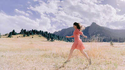 Elise Sandidge running through a field