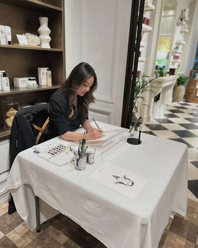 Calligraphy artist painting in store