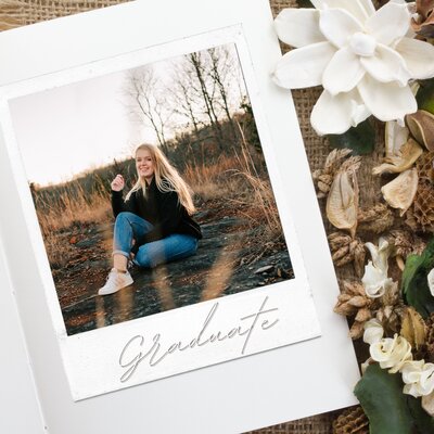 high school senior grad card of girl sitting in field during Springfield Mo senior photography session