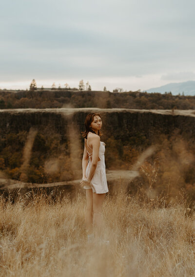 girl standing in field in Oregon