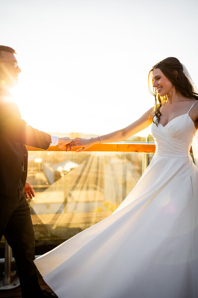 A stunning backdrop of sunset and rooftop views at Lindsey and Ken's  wedding in Cincinnati at Rheingeist Br. This image highlights our expert ability to blend natural light photography with architectural beauty, ideal for couples planning a destination wedding in Cincinnati.