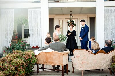 Nashville Micro Wedding with bride and groom at home and guests seated on peach velvet couches