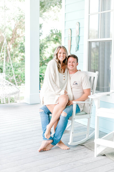 Blue Marlin Real Estate owners share a kiss on their front porch