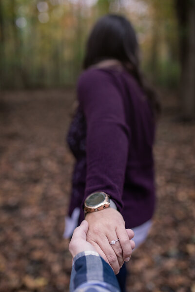 couple holds hands for engagement pictures in New Jersey